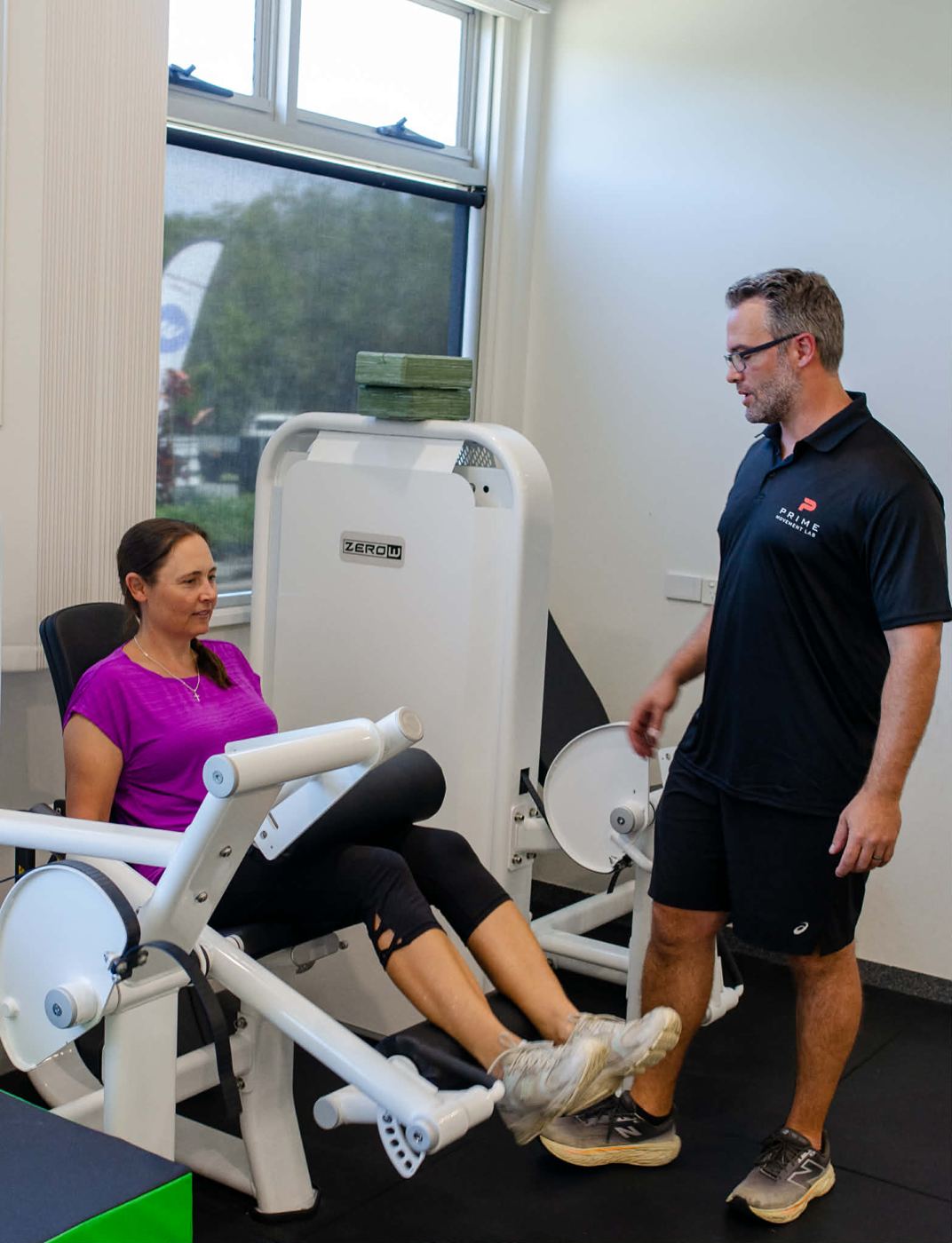 Mathew talking a client through a leg extension exercise