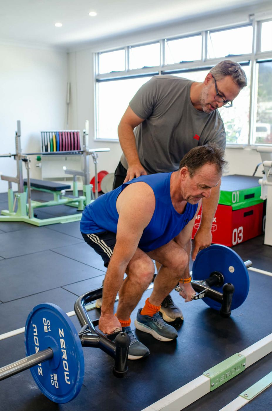 Mathew coaching a client through a trap bar deadlift at ZeroW Currumbin